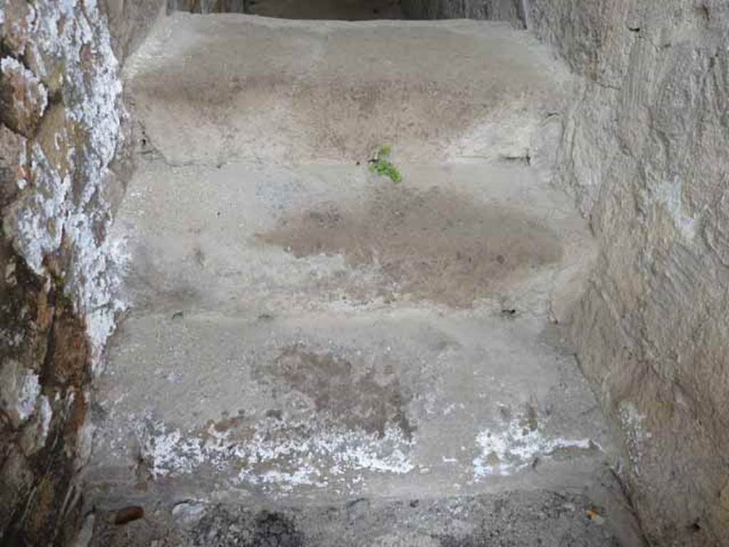 V.2, Herculaneum. May 2010. Base of steps to upper floor in doorway.